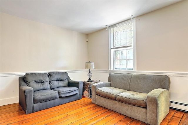 living room with wood-type flooring and baseboard heating