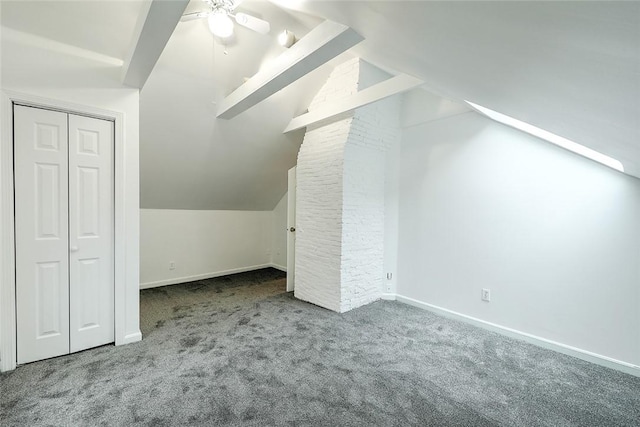 additional living space with vaulted ceiling with beams, baseboards, and carpet floors