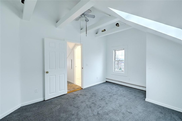 additional living space with ceiling fan, vaulted ceiling with skylight, baseboards, baseboard heating, and carpet