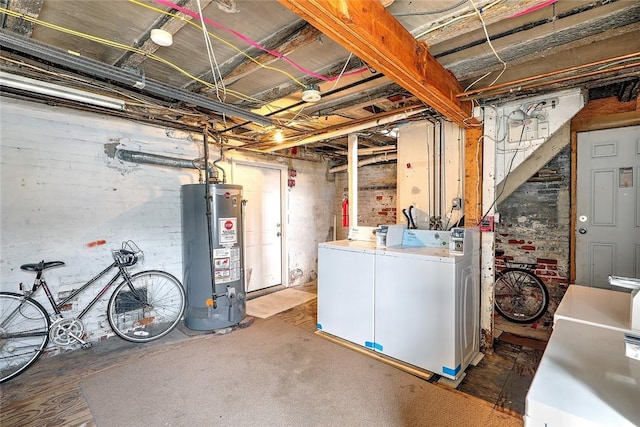 unfinished basement featuring water heater and washer and clothes dryer