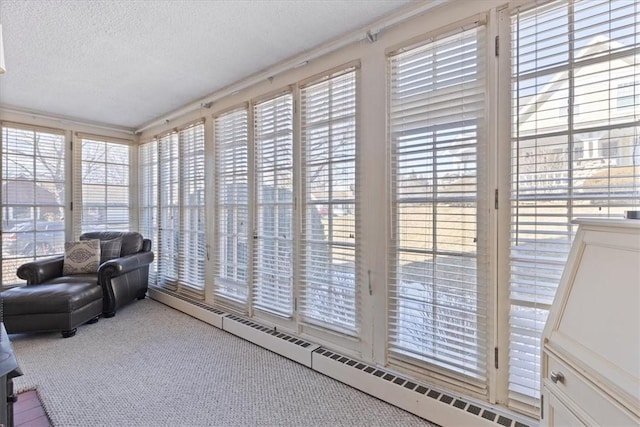 sunroom / solarium featuring a baseboard radiator and a wealth of natural light