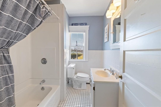 full bath with toilet, vanity, tile walls, tile patterned floors, and shower / bathtub combination with curtain