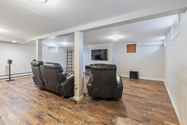 interior space featuring a baseboard radiator, wood finished floors, and baseboards