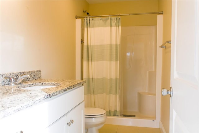 bathroom featuring toilet, tile patterned floors, vanity, and a shower with shower curtain