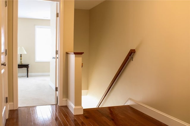 stairway featuring hardwood / wood-style flooring and baseboards