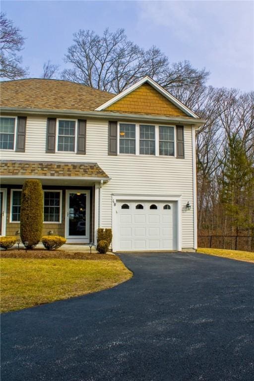 traditional-style home with driveway and an attached garage