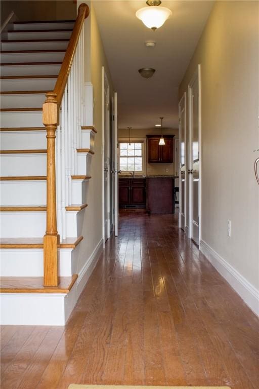 interior space featuring baseboards and hardwood / wood-style floors