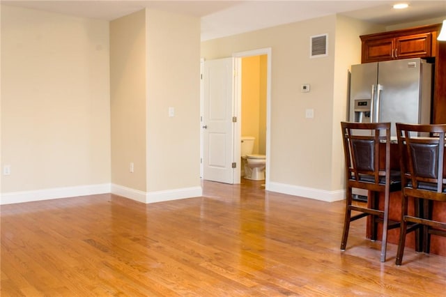 interior space featuring light wood-style floors, recessed lighting, visible vents, and baseboards