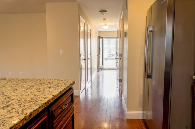 hall with baseboards and dark wood finished floors