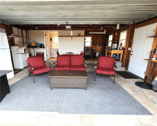 interior space with a garage door opener and freestanding refrigerator