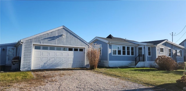 single story home featuring gravel driveway, an outdoor structure, and a front yard