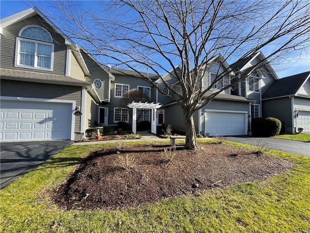 traditional home featuring a garage and driveway