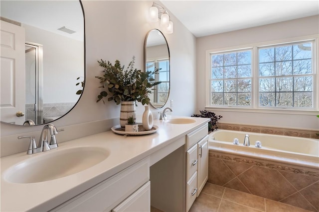 full bathroom with tile patterned flooring, visible vents, a sink, and a bath