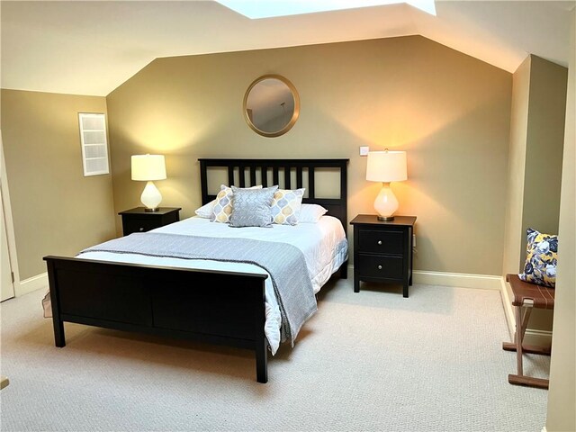 bedroom featuring lofted ceiling, baseboards, and carpet floors