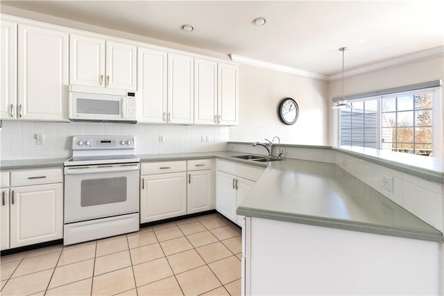 kitchen featuring a peninsula, white appliances, light tile patterned flooring, and a sink