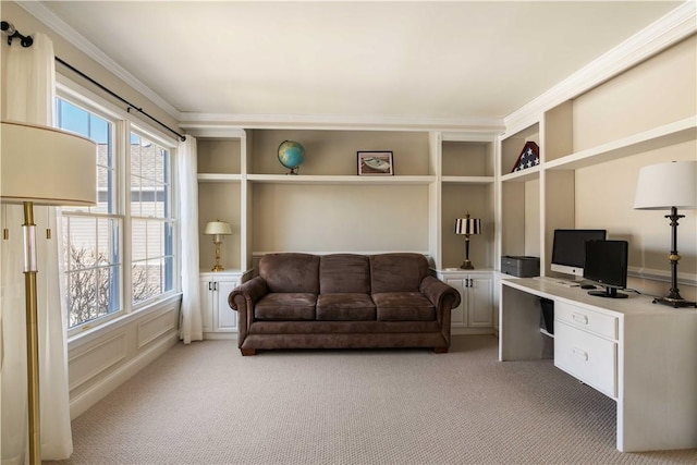 office space featuring light colored carpet, built in study area, and crown molding