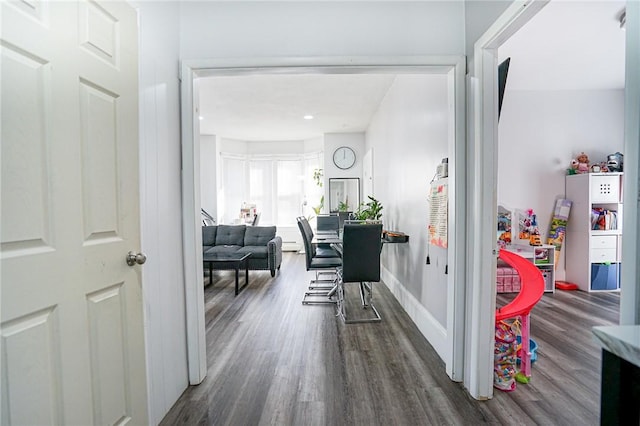 hall with dark wood-style floors and baseboards