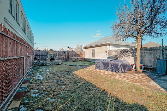 view of yard featuring a patio area and a fenced backyard