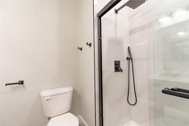 bathroom featuring a stall shower and toilet