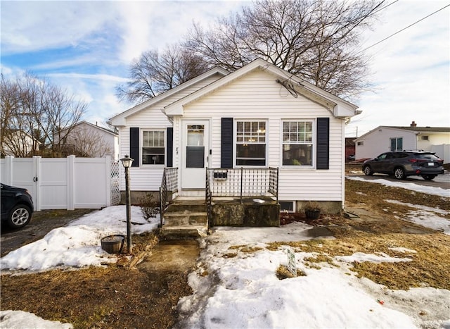 bungalow-style house with a porch and fence