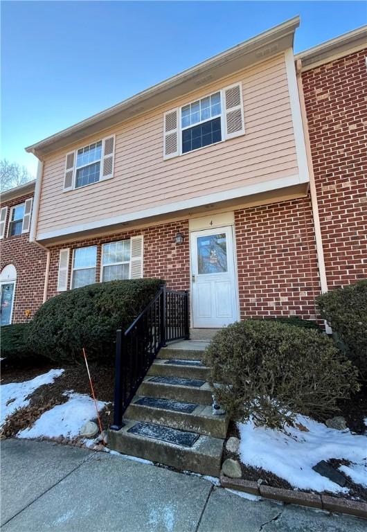 view of property with brick siding