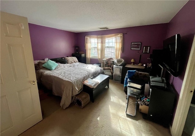 bedroom featuring visible vents and a textured ceiling