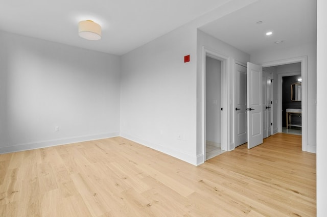 empty room featuring wood finished floors and baseboards