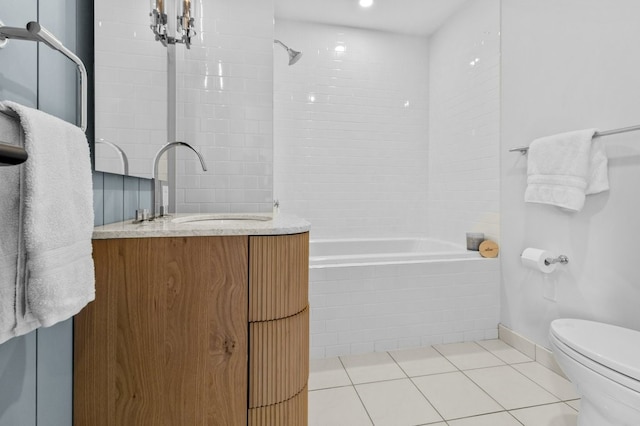 full bathroom featuring toilet, tiled shower / bath, vanity, and tile patterned floors