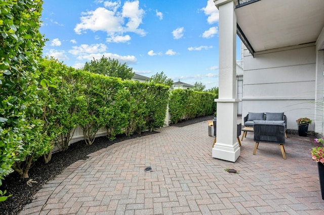 view of patio featuring fence and an outdoor hangout area