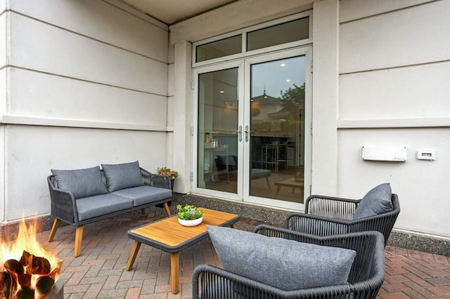 view of patio featuring french doors and an outdoor living space with a fire pit