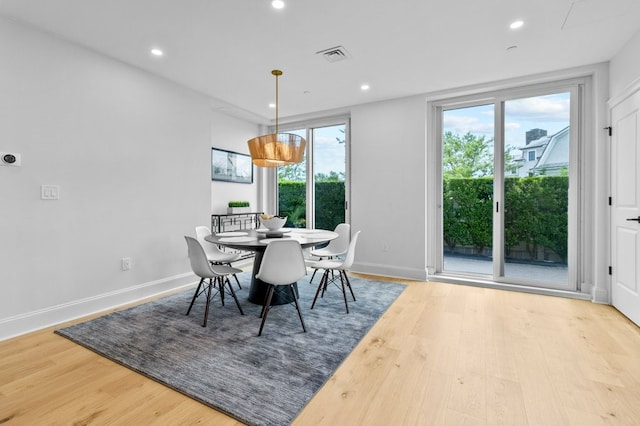 dining space with recessed lighting, visible vents, and wood finished floors