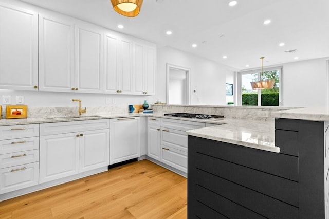 kitchen with recessed lighting, a sink, white cabinets, dishwasher, and light wood finished floors