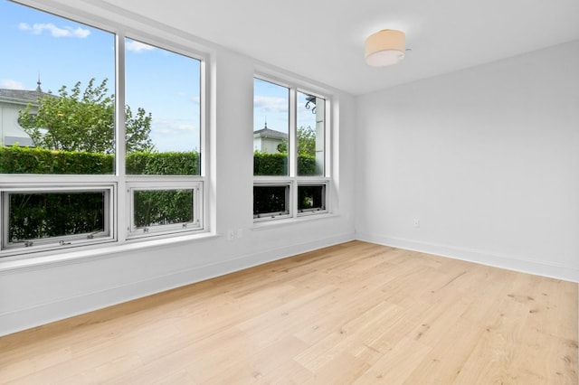 empty room featuring light wood-style flooring and baseboards