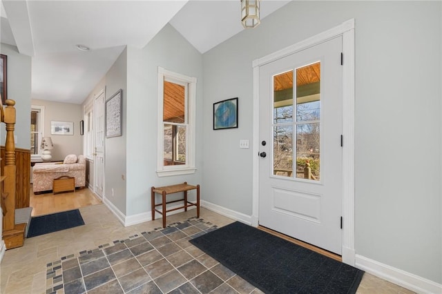 entrance foyer with lofted ceiling and baseboards