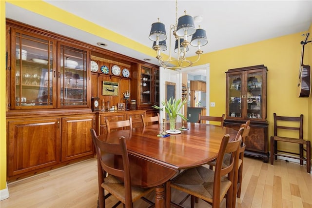 dining room featuring a chandelier and light wood finished floors