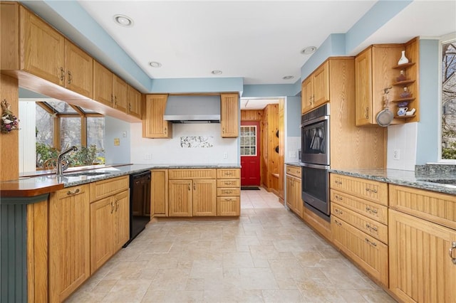 kitchen featuring black dishwasher, stone countertops, wall chimney exhaust hood, stainless steel double oven, and a sink