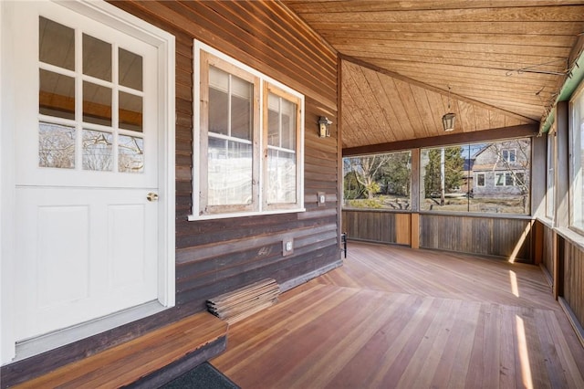 unfurnished sunroom featuring vaulted ceiling and wood ceiling