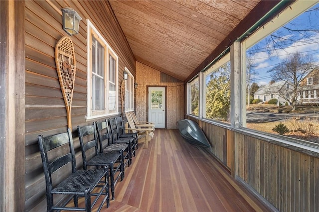 sunroom / solarium featuring lofted ceiling and wood ceiling