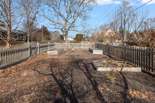 view of yard featuring a garden and a fenced backyard