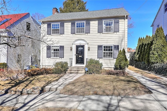 colonial inspired home with a chimney