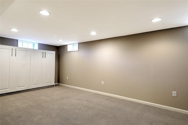 basement with recessed lighting, baseboards, and light colored carpet