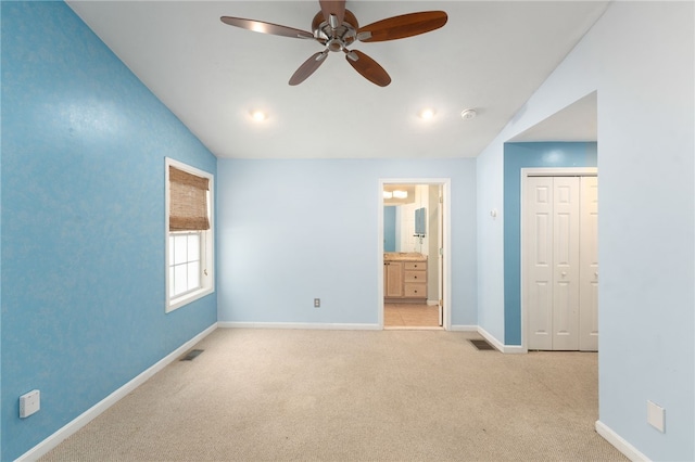 unfurnished bedroom with carpet flooring, vaulted ceiling, visible vents, and baseboards