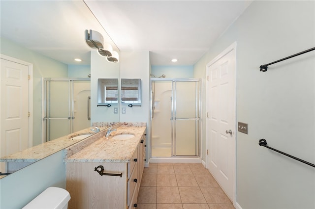 full bath with a stall shower, vanity, toilet, and tile patterned floors