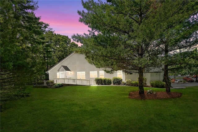 view of front of property featuring a deck and a front lawn