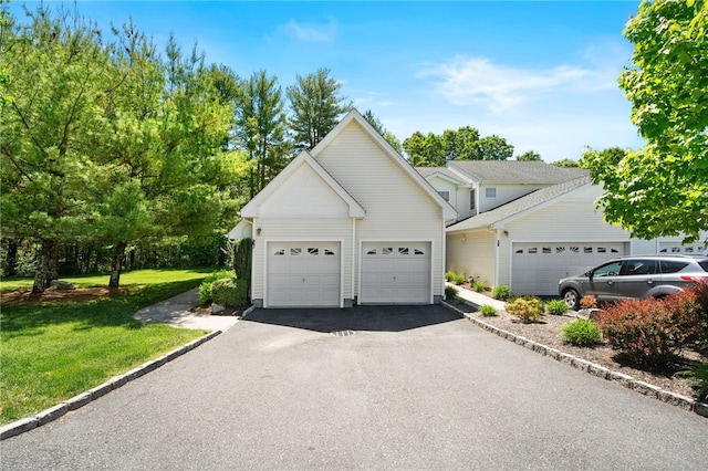 view of front of home featuring a front yard, driveway, and an attached garage