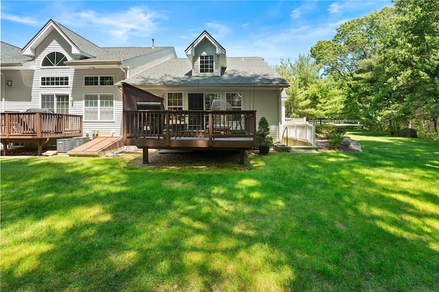 back of property with a lawn and a wooden deck