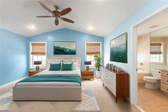 bedroom with visible vents, light carpet, connected bathroom, vaulted ceiling, and ceiling fan