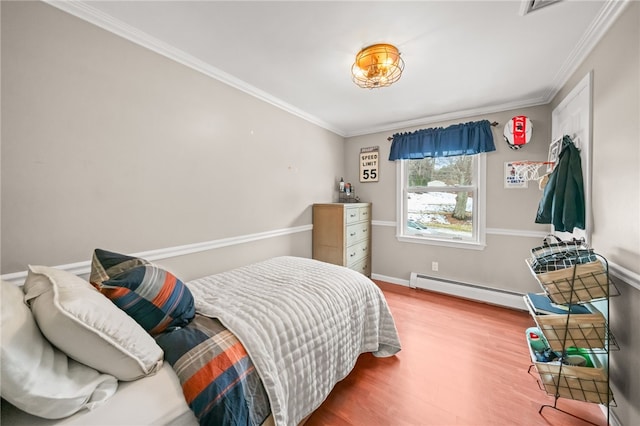 bedroom with baseboards, ornamental molding, baseboard heating, and wood finished floors