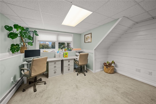 office area with carpet floors, a baseboard radiator, and a drop ceiling