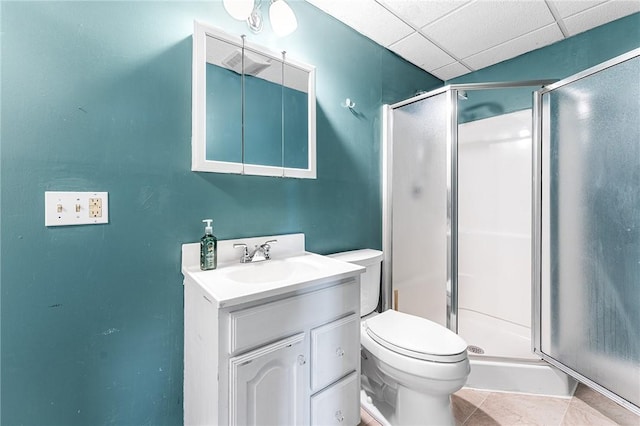 full bath with toilet, a shower stall, a paneled ceiling, and vanity